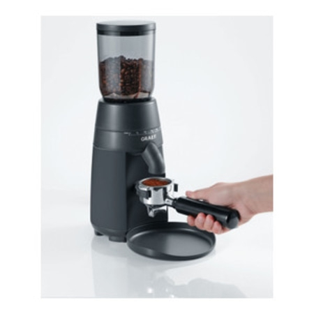 Coffee grinder with beans and portafilter, ready for espresso.