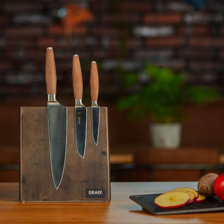 Küchenmesser-Set mit Holzgriffen und Halterung auf einem Holztisch