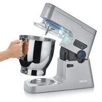 Graef kitchen machine with bowl and hand holding the bowl, silver color