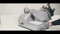 Meat slicer with dimensions of 600 x 570 x 420 mm, gray color, white tray.
