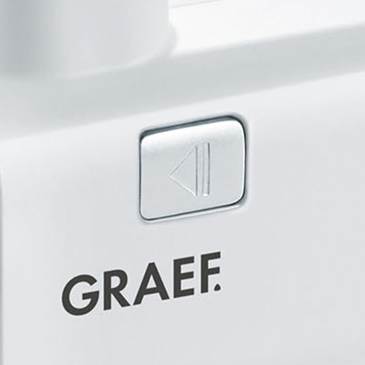 White Graef appliance with play button and logo on white surface