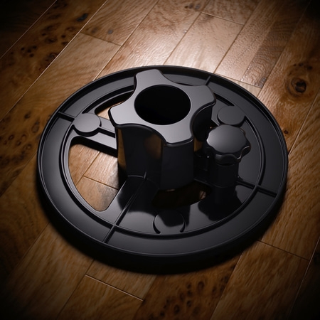 Schwarzes Objekt auf Holz. Runde Basis, Stern, Knöpfe. Glänzende Oberfläche.