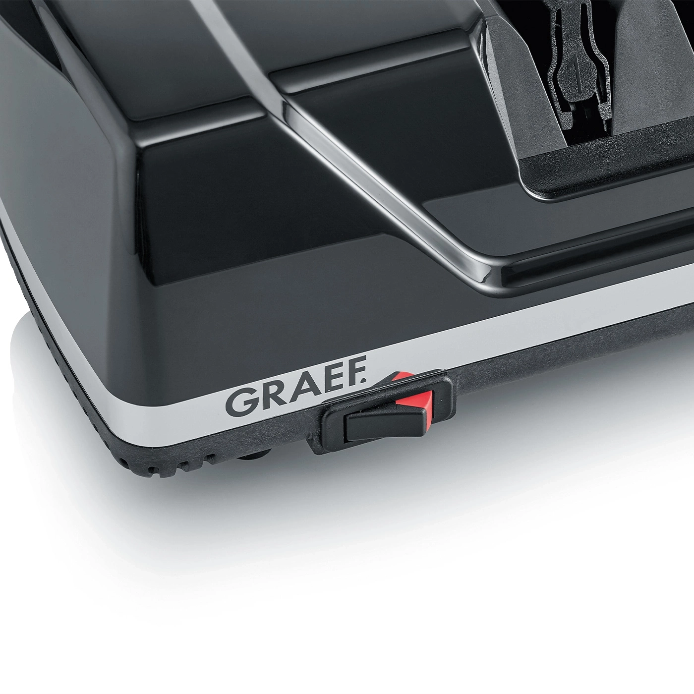 Schwarzes Gerät mit GRAEF-Logo und rotem Schalter, Nahaufnahme, glänzend.