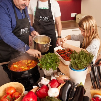 Famille cuisinant ensemble dans la cuisine, légumes et ustensiles de cuisine.