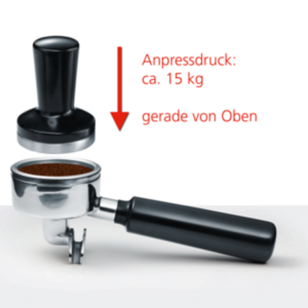 Coffee grounds being tamped in a portafilter with a tamper, pressing down.