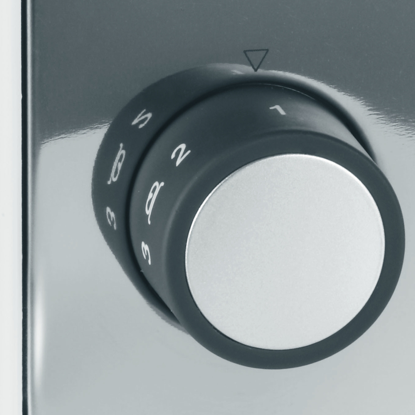 Rotary knob with numbers, triangle marker, gray background, close-up, appliance