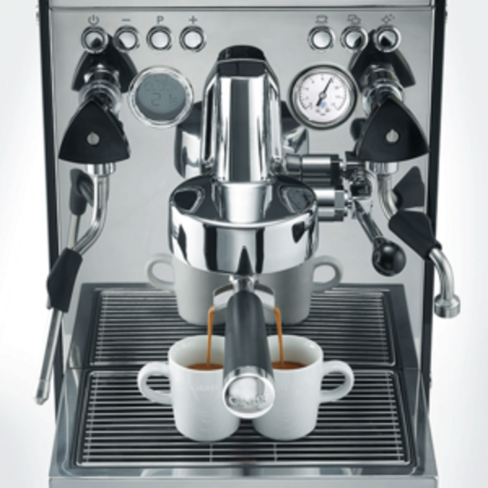 Espresso machine brewing coffee into two white cups.