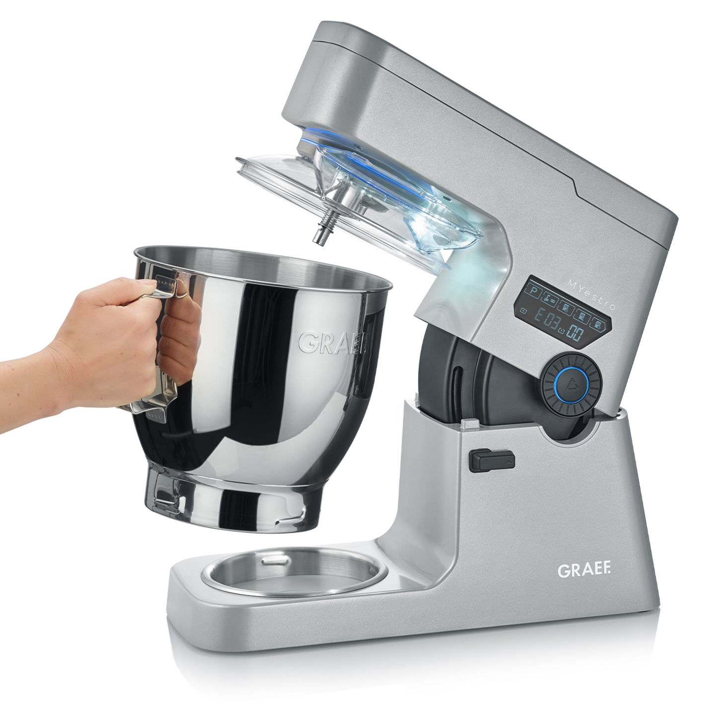 Graef kitchen machine with bowl and hand holding the bowl, silver color