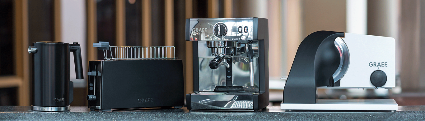 Graef kitchen appliances: kettle, toaster, espresso machine and slicer on a countertop.