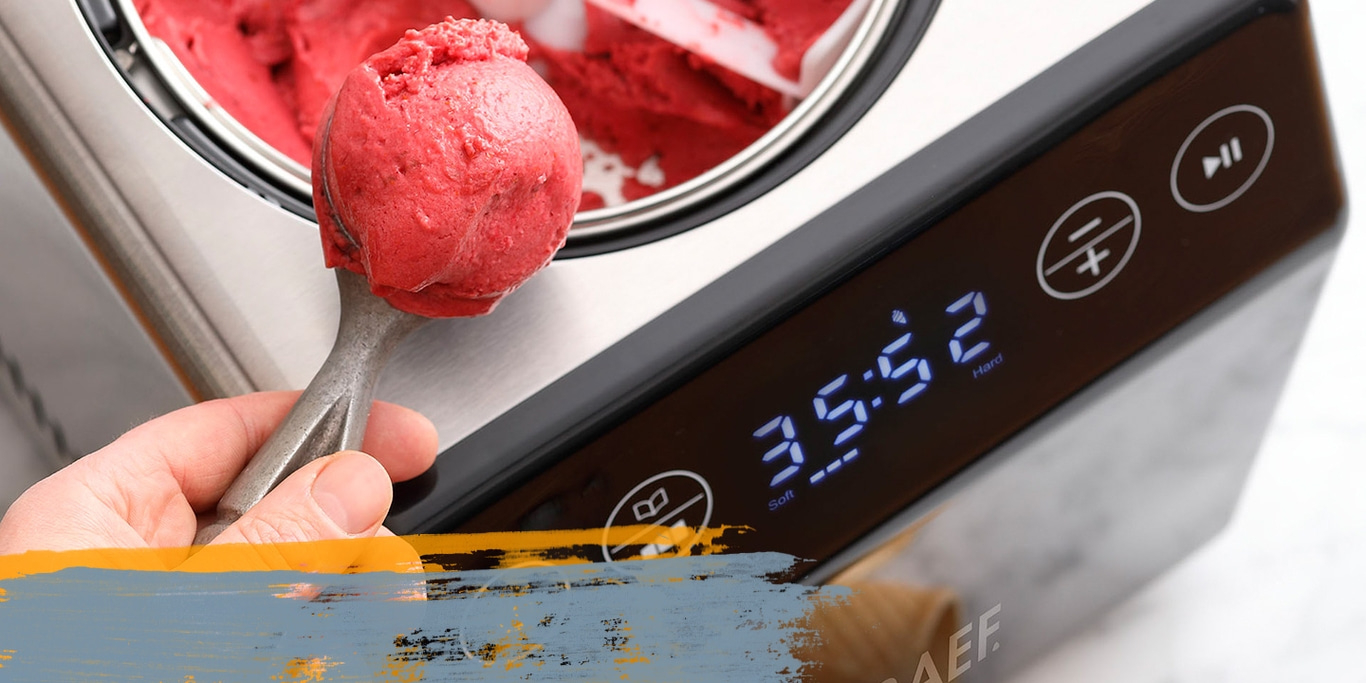 Ice cream being scooped from an ice cream maker with a spoon.