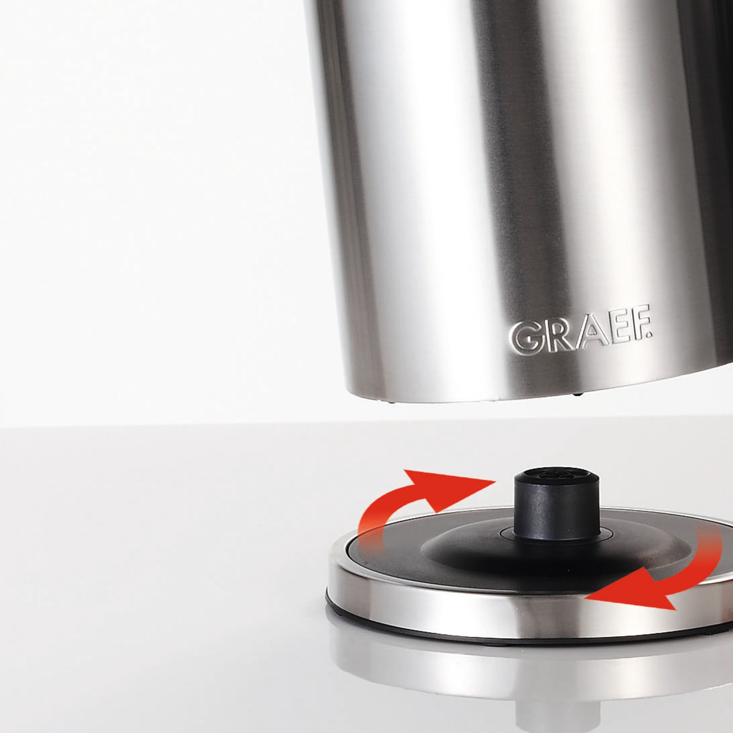 Stainless steel kettle with rotating base and arrows indicating rotation, GRAEF logo visible.